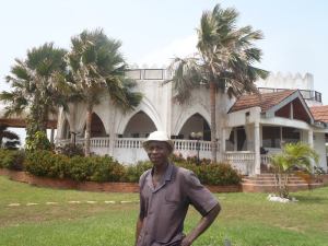 M. Kassim in front of the President's holiday home